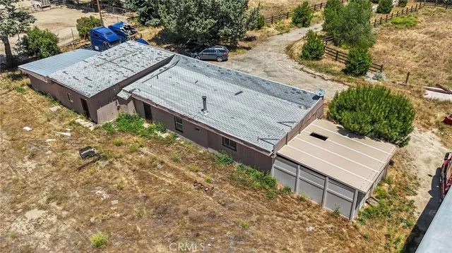 a view of a wooden bench in front of house