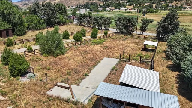a view of backyard with seating space and trees