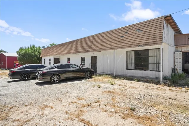 a view of a cars parking space in front of a house