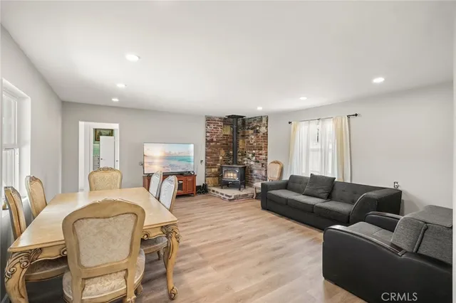 a living room with furniture fireplace and a window