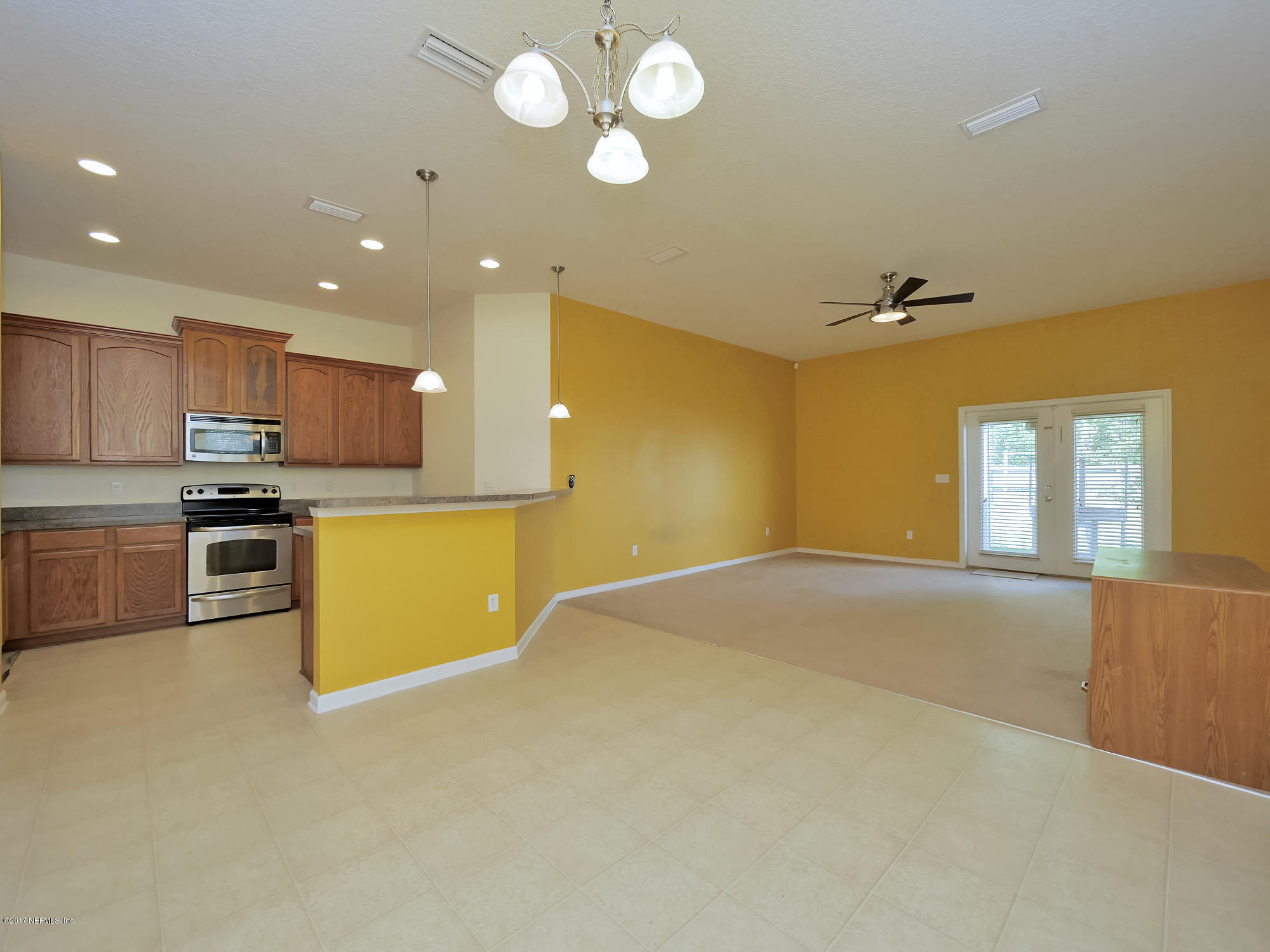 9146 Raptor Drive Jacksonville, FL 32221 - Photo 12 of 26 a view of a kitchen with a sink and dishwasher a refrigerator with wooden floor
