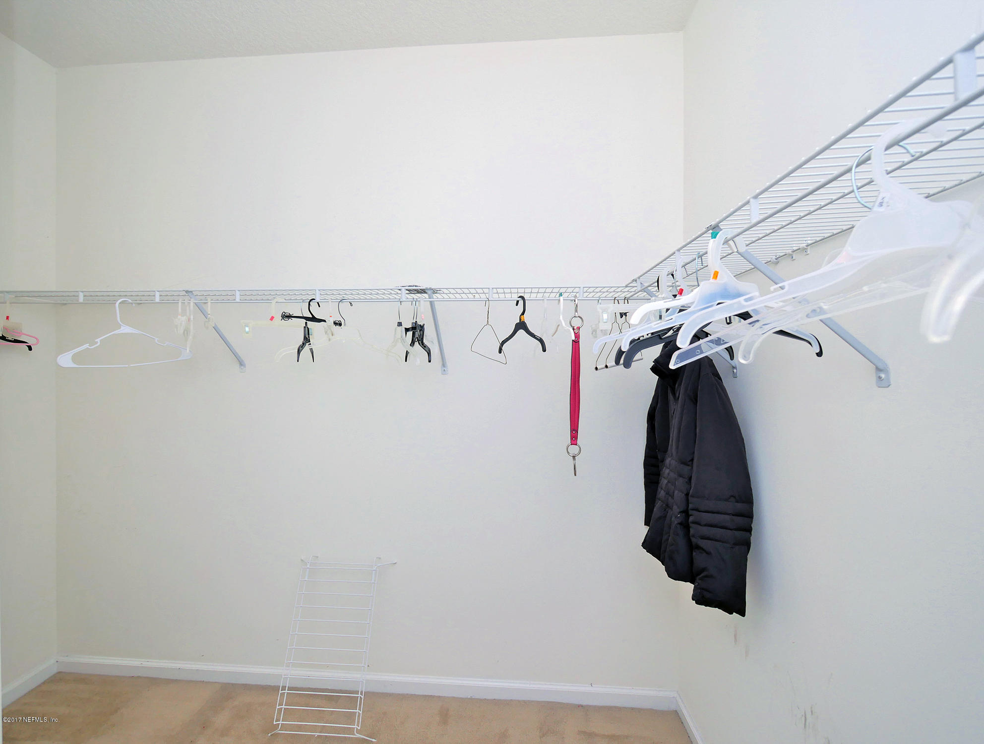 9146 Raptor Drive Jacksonville, FL 32221 - Photo 16 of 26 a view of walk in closet with clothes
