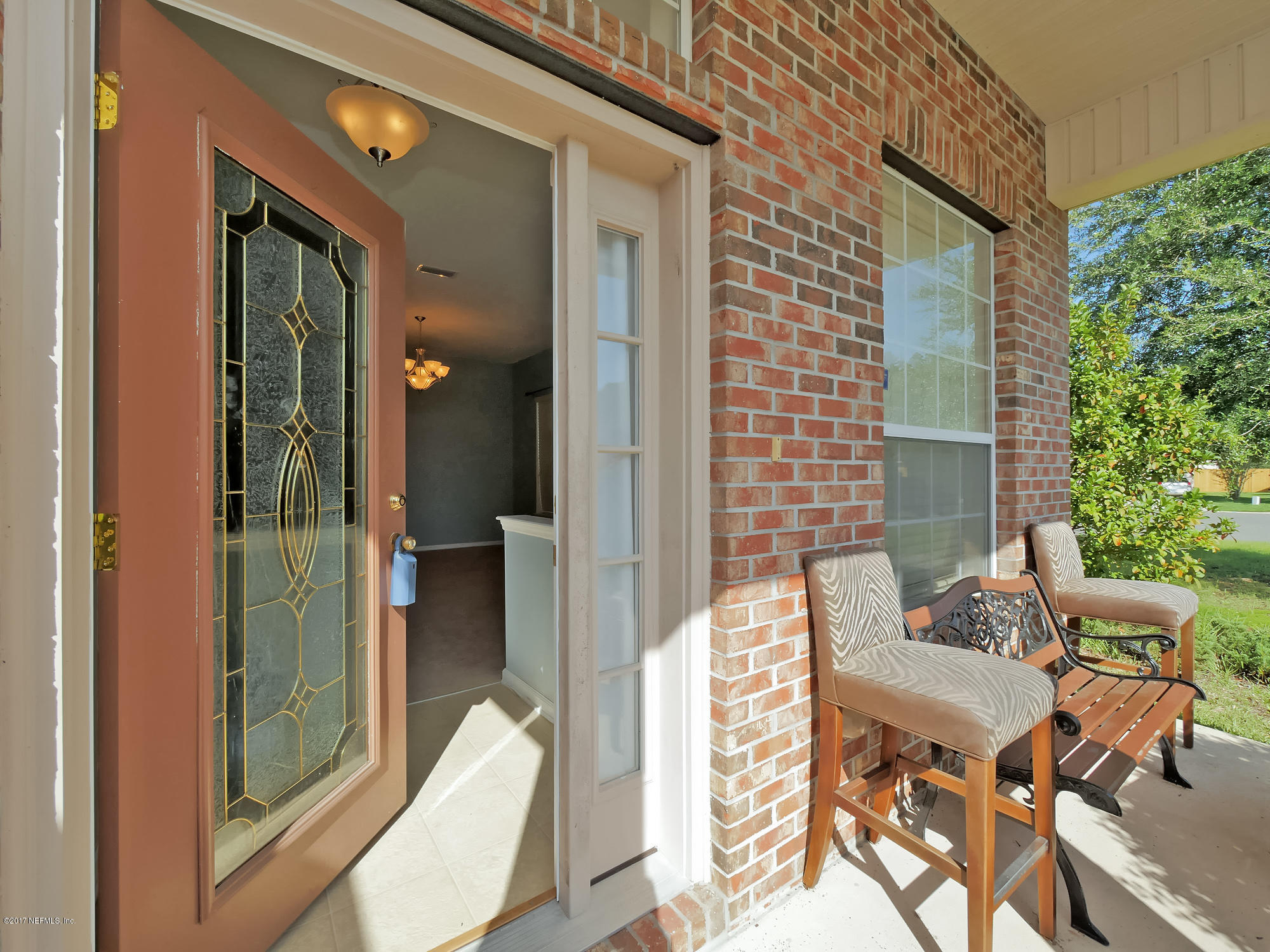 9146 Raptor Drive Jacksonville, FL 32221 - Photo 3 of 26 a balcony with table and chairs