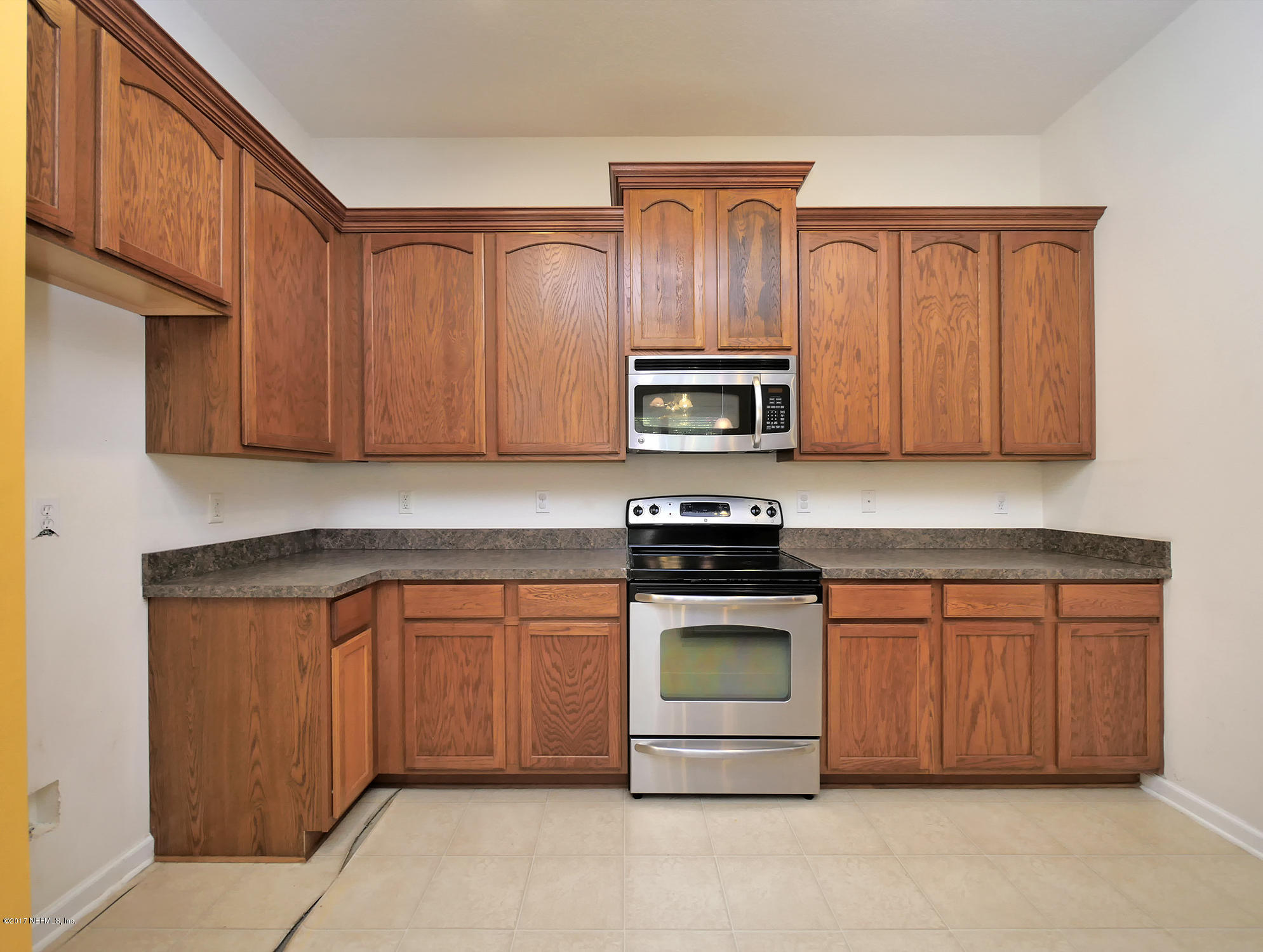 9146 Raptor Drive Jacksonville, FL 32221 - Photo 8 of 26 a kitchen with stainless steel appliances granite countertop a stove a sink dishwasher and a microwave oven