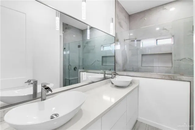 a bathroom with a double vanity sink and a mirror