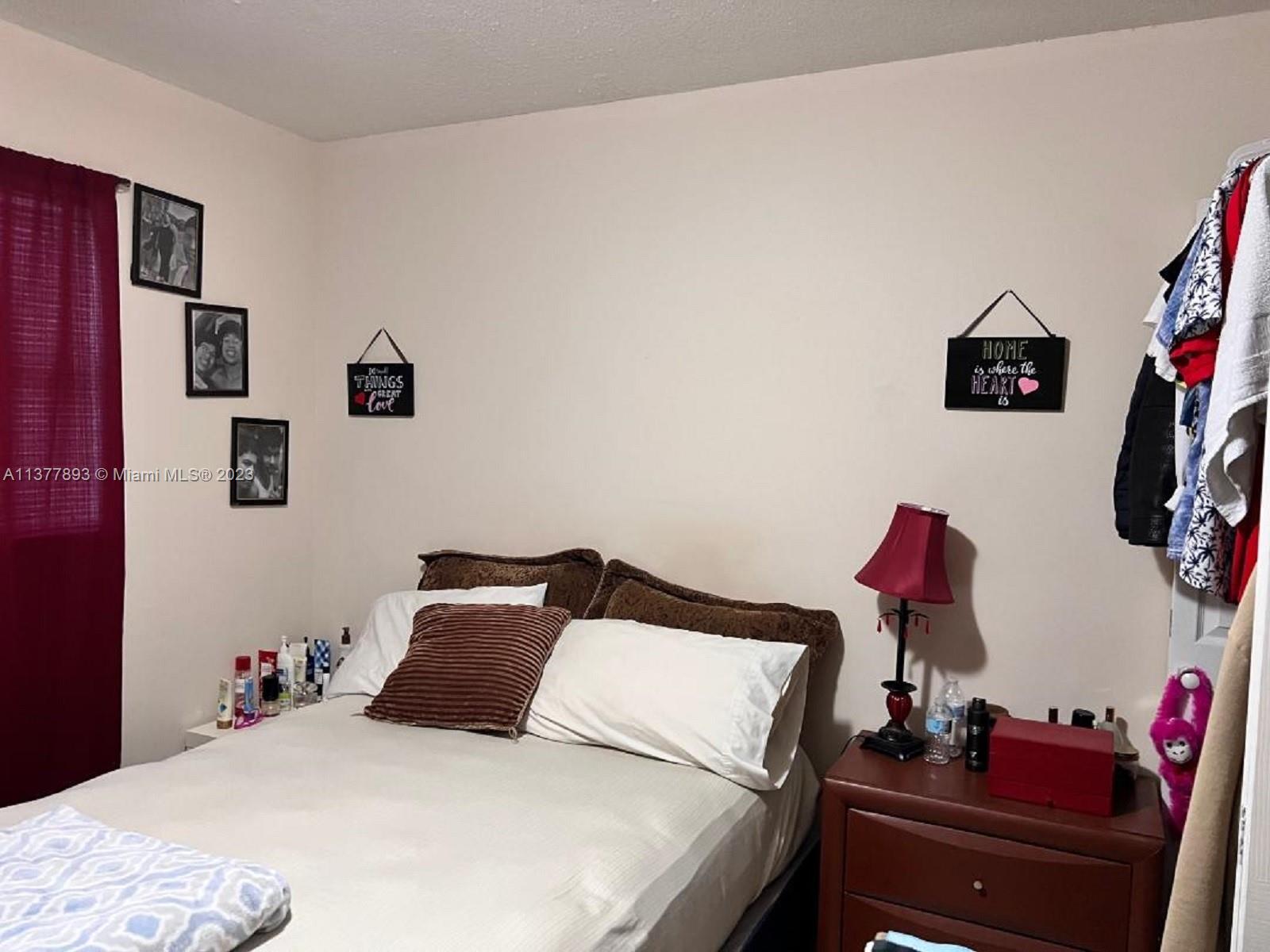 15465 Southwest 80th Street, Unit 2014 Miami, FL 33193 - Photo 11 of 23 a bedroom with a bed and a desk