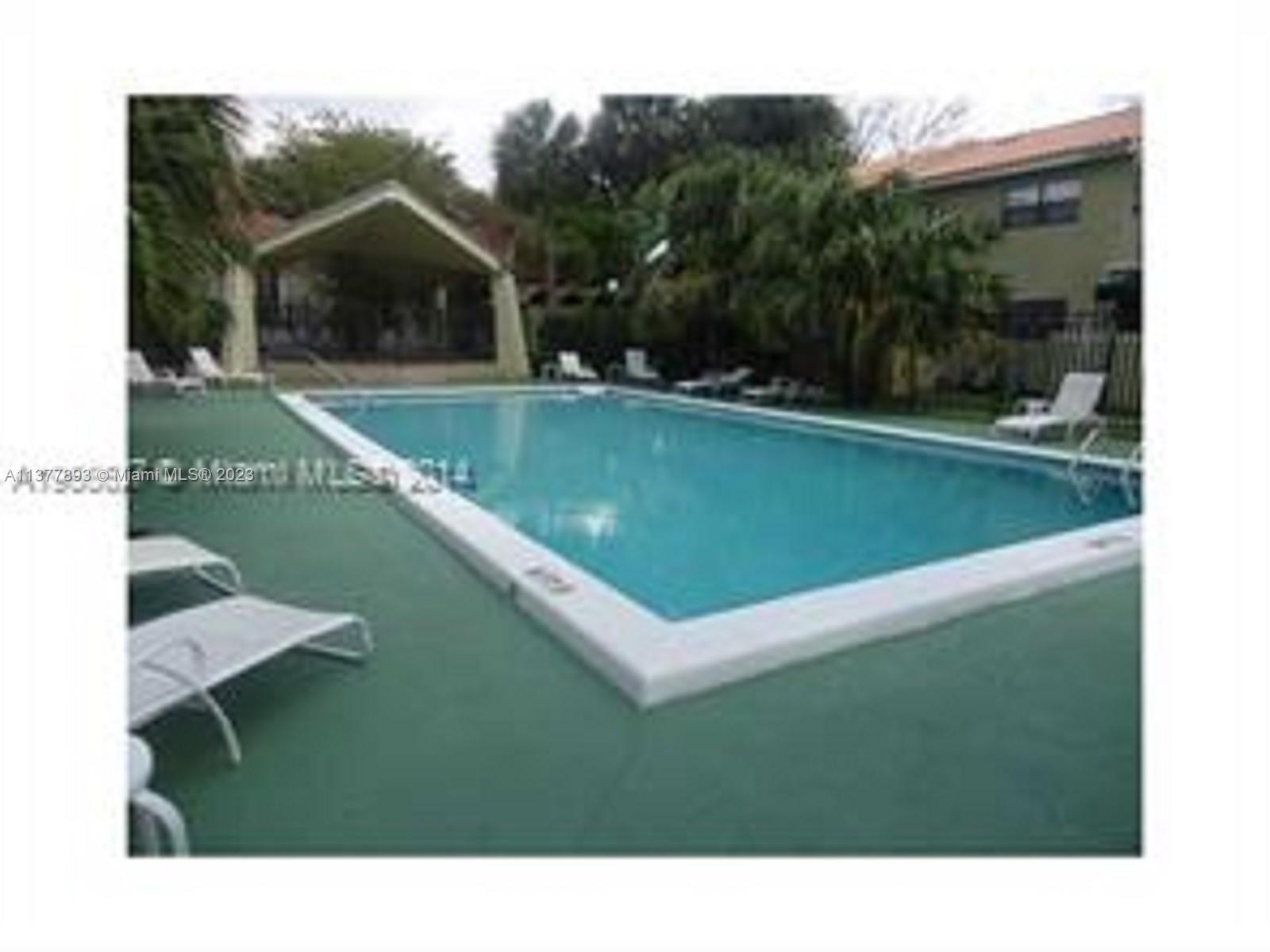 15465 Southwest 80th Street, Unit 2014 Miami, FL 33193 - Photo 15 of 23 a view of a swimming pool with a yard