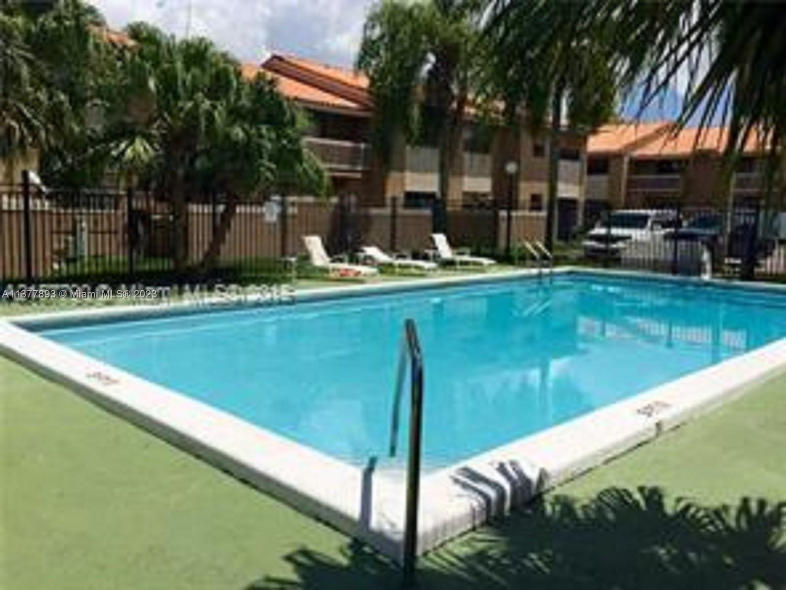 15465 Southwest 80th Street, Unit 2014 Miami, FL 33193 - Photo 16 of 23 a swimming pool with outdoor seating and yard