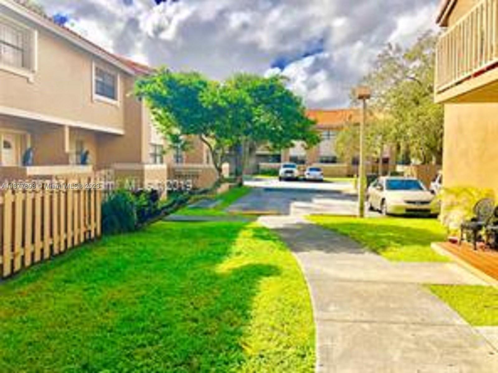 15465 Southwest 80th Street, Unit 2014 Miami, FL 33193 - Photo 18 of 23 a view of backyard with swimming pool and green space