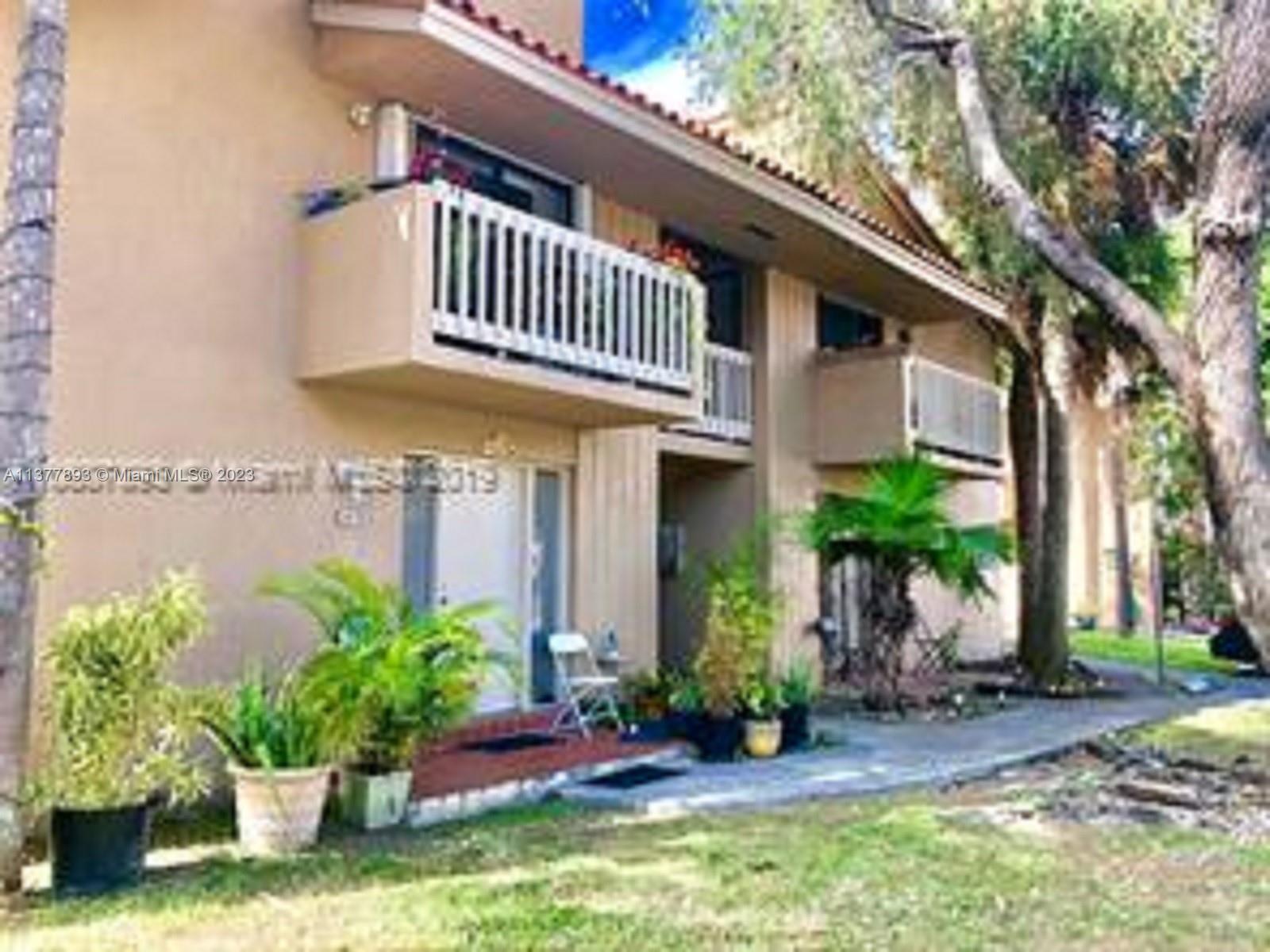 15465 Southwest 80th Street, Unit 2014 Miami, FL 33193 - Photo 20 of 23 a view of a house with a yard and plants