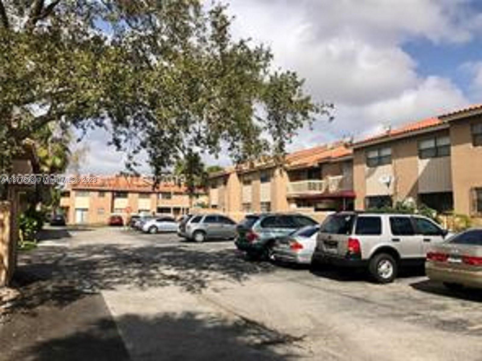 15465 Southwest 80th Street, Unit 2014 Miami, FL 33193 - Photo 21 of 23 a view of a cars parked in front of a building