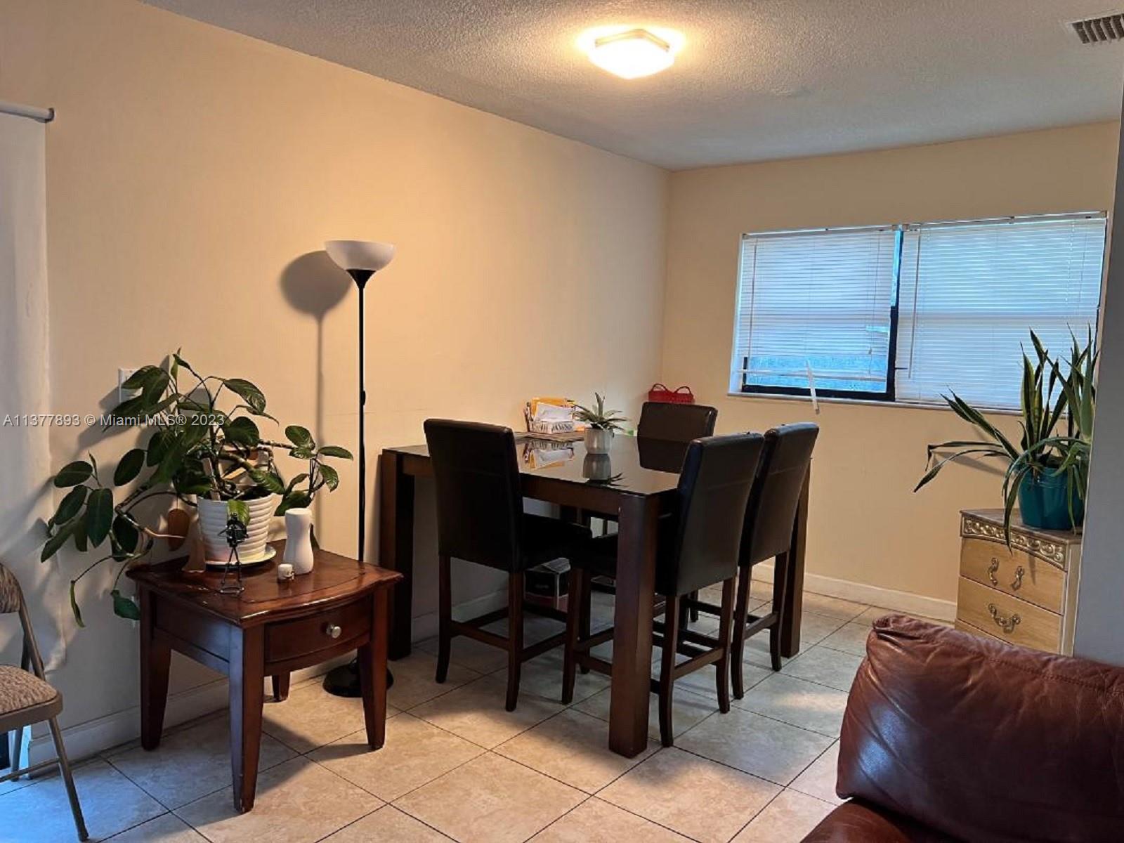 15465 Southwest 80th Street, Unit 2014 Miami, FL 33193 - Photo 3 of 23 a view of a dining room with furniture