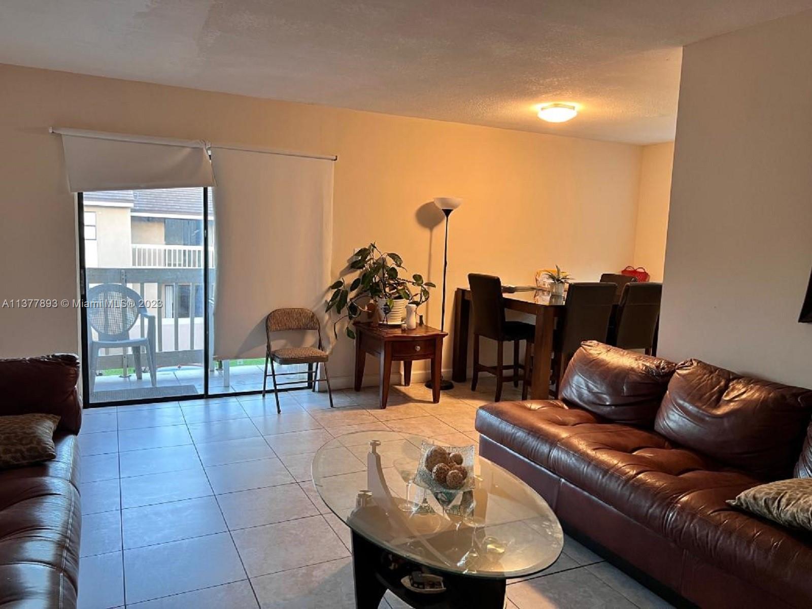 15465 Southwest 80th Street, Unit 2014 Miami, FL 33193 - Photo 4 of 23 a living room with furniture and wooden floor