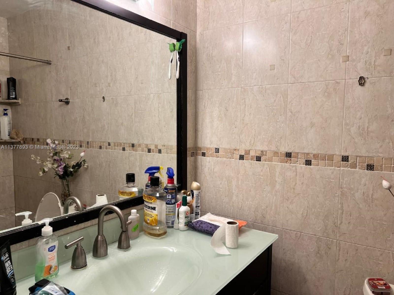 15465 Southwest 80th Street, Unit 2014 Miami, FL 33193 - Photo 6 of 23 a bathroom with a sink and a mirror