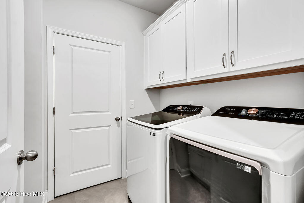 142 Rice Marsh Way Wilmington, NC 28412 - Photo 35 of 64 This pass-through laundry room features a built-in folding station and connects one of the owner's suite walk-in closets to the entryway.