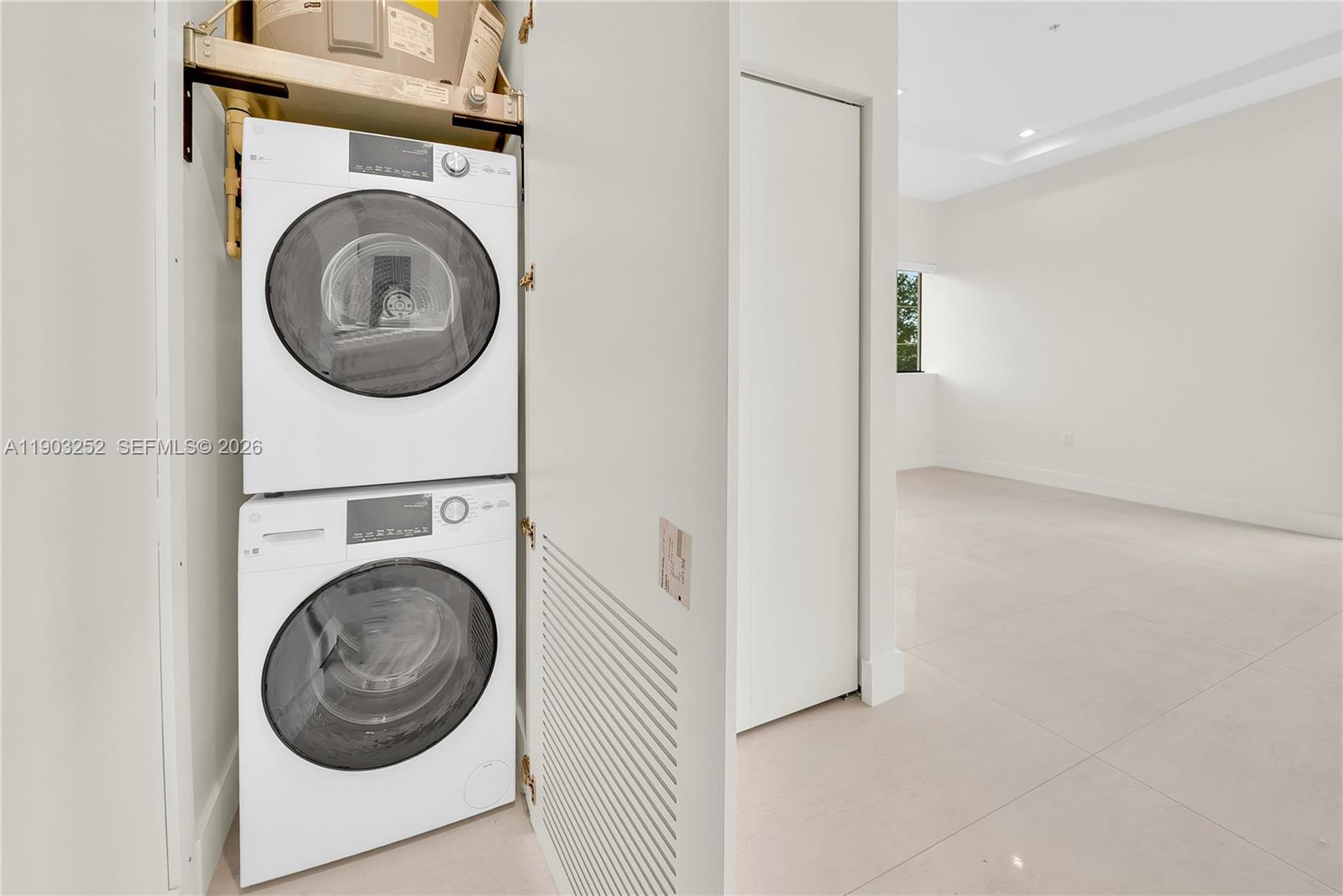 a view of a hallway with washer and dryer