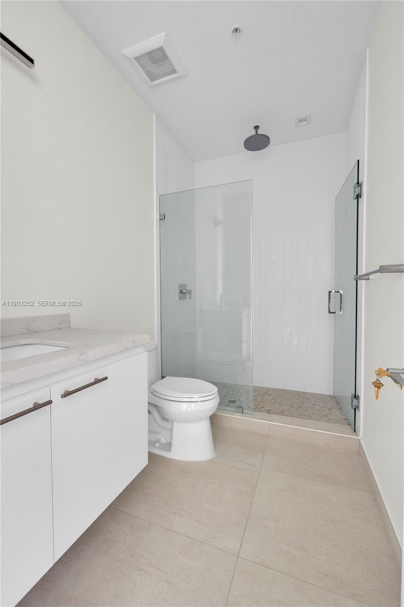530 Southwest 11th Avenue, Unit 103 Miami, FL 33130 - Photo 16 of 18 a bathroom with a toilet sink and shower