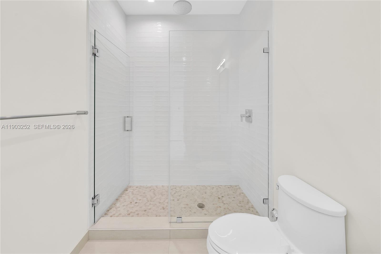 530 Southwest 11th Avenue, Unit 103 Miami, FL 33130 - Photo 17 of 18 a bathroom with a toilet and a shower