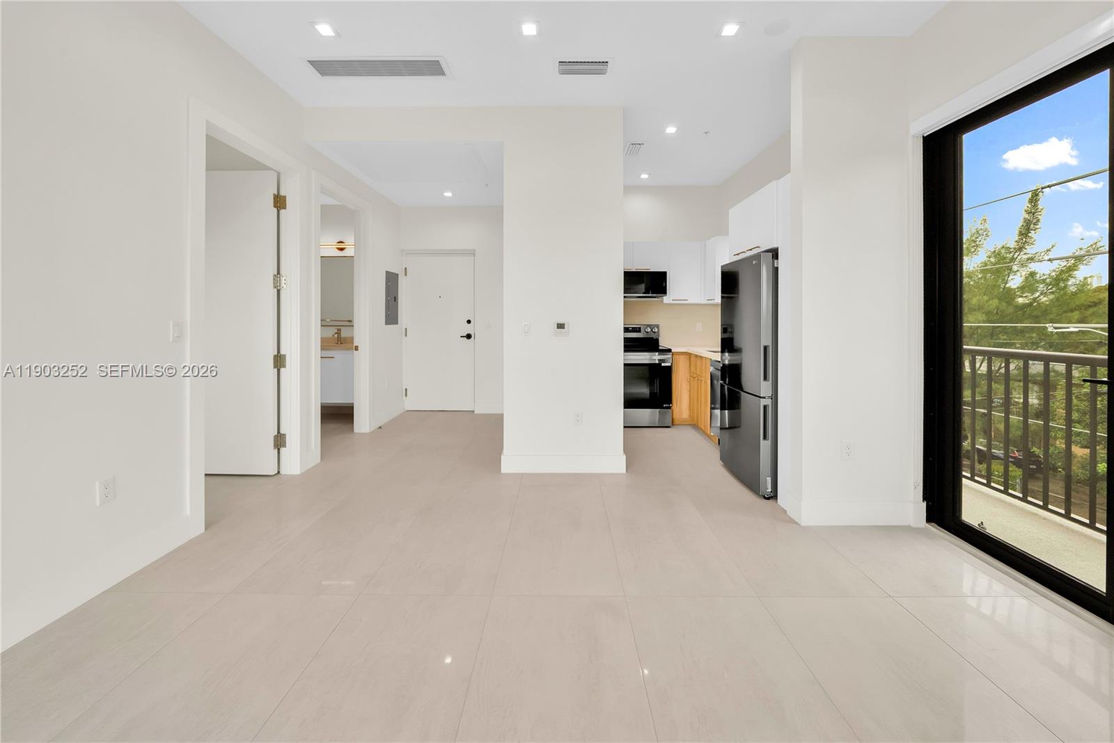 530 Southwest 11th Avenue, Unit 103 Miami, FL 33130 - Photo 4 of 18 a view of a big room with closet and windows