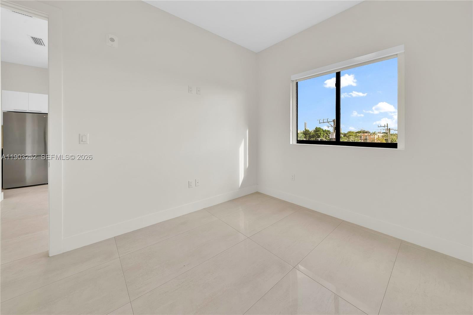 530 Southwest 11th Avenue, Unit 103 Miami, FL 33130 - Photo 8 of 18 an empty room with a window