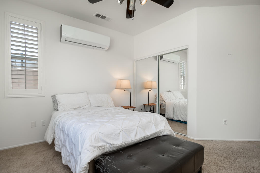 83460 Lone Star Road Indio, CA 92203 - Photo 14 of 40 a bedroom with a bed a mirror and lamp