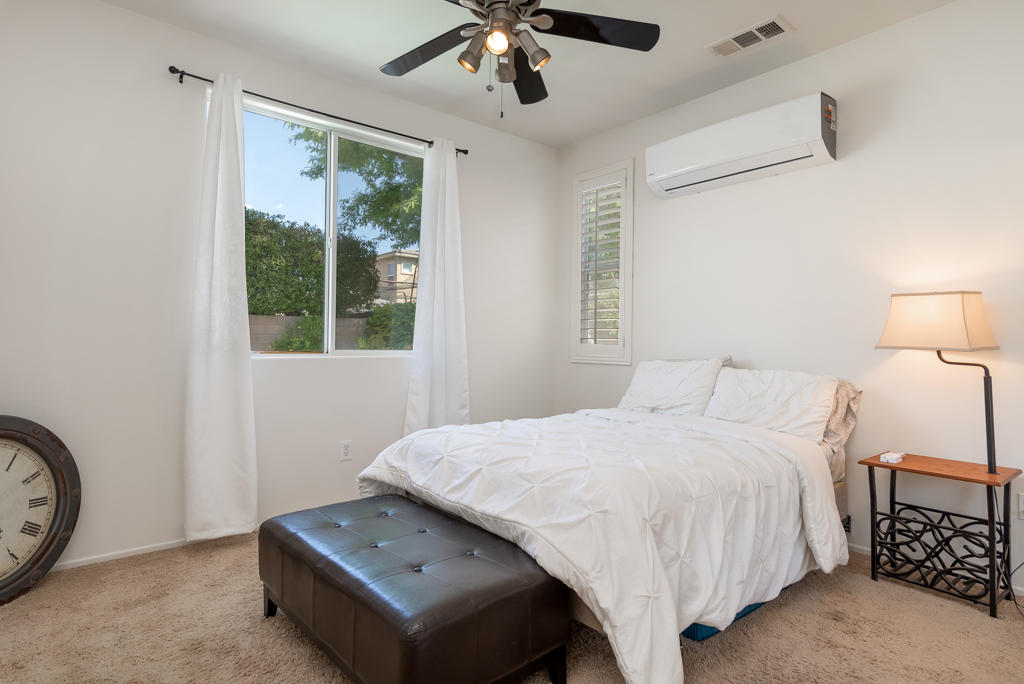 83460 Lone Star Road Indio, CA 92203 - Photo 15 of 40 a bedroom with a bed and a chandelier