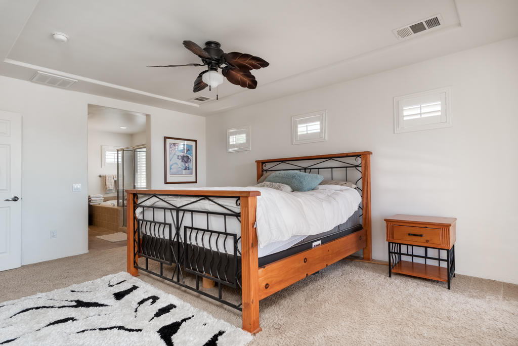 83460 Lone Star Road Indio, CA 92203 - Photo 19 of 40 a bedroom with a bed and a chandelier