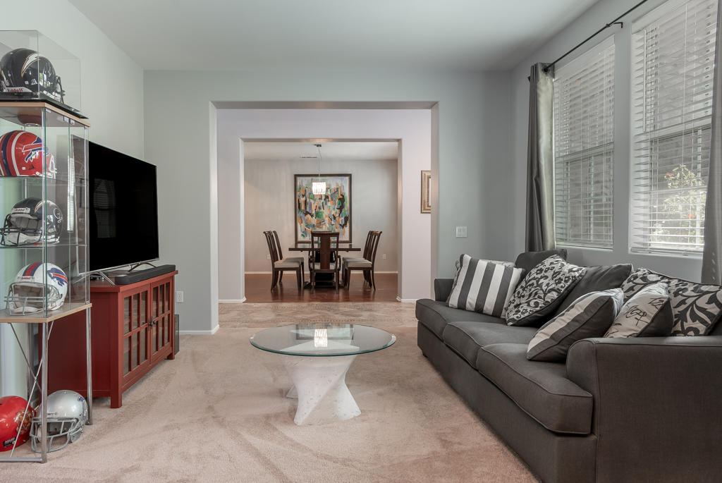 83460 Lone Star Road Indio, CA 92203 - Photo 3 of 40 a living room with furniture a flat screen tv and a large window