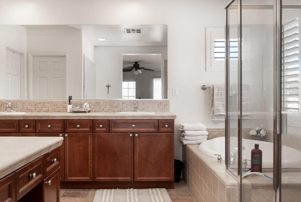 83460 Lone Star Road Indio, CA 92203 - Photo 23 of 40 a bathroom with a granite countertop sink a toilet a mirror and bathtub