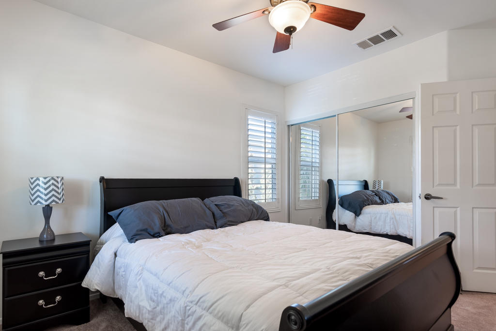 83460 Lone Star Road Indio, CA 92203 - Photo 28 of 40 a bedroom with a bed and a chandelier