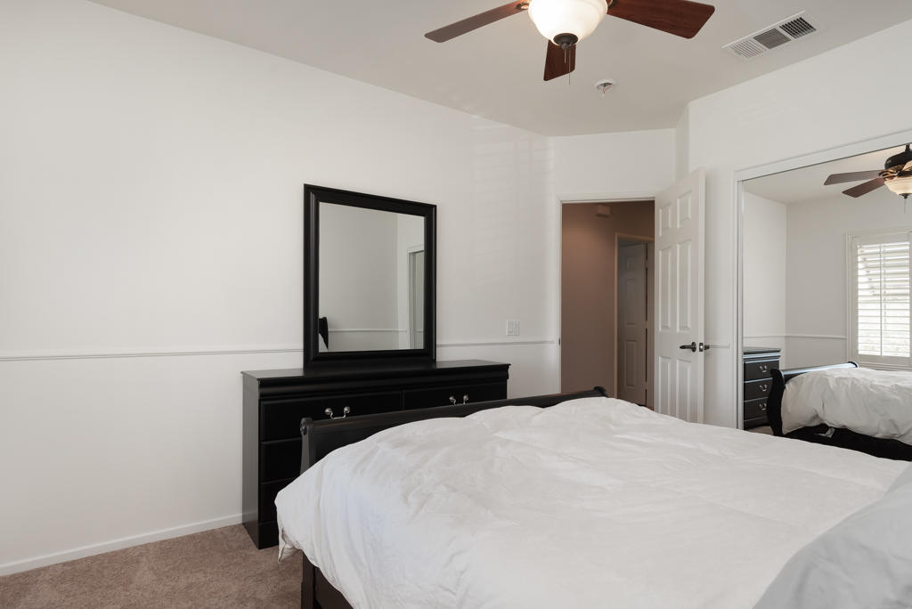 83460 Lone Star Road Indio, CA 92203 - Photo 29 of 40 a bedroom with a bed and a chandelier