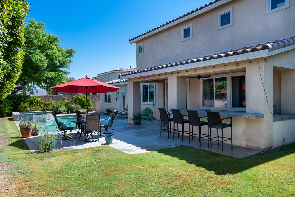 83460 Lone Star Road Indio, CA 92203 - Photo 34 of 40 a swimming pool with outdoor seating water slide and yard