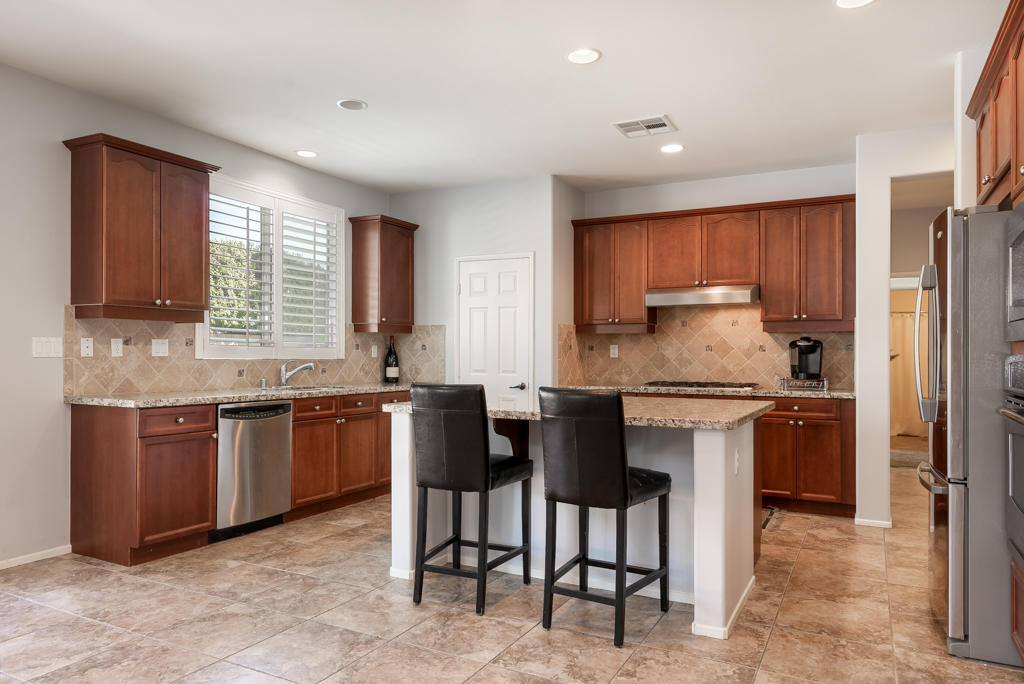 83460 Lone Star Road Indio, CA 92203 - Photo 6 of 40 a kitchen with stainless steel appliances granite countertop a stove a sink and a refrigerator