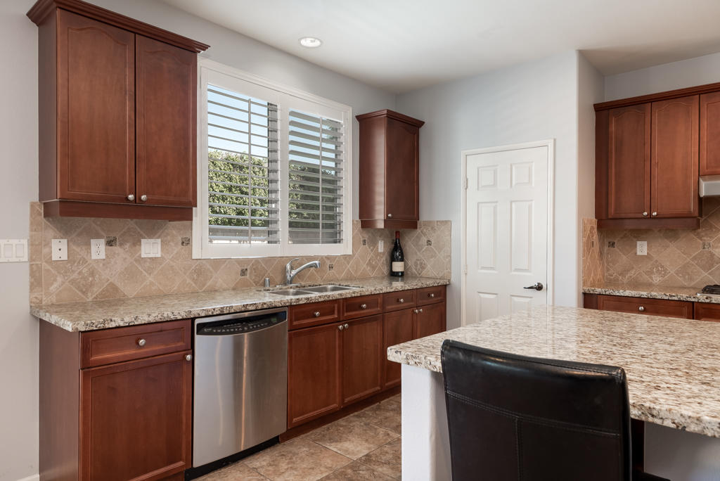 83460 Lone Star Road Indio, CA 92203 - Photo 8 of 40 a kitchen with a sink stove and cabinets