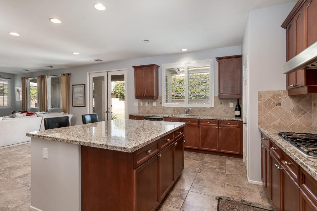 83460 Lone Star Road Indio, CA 92203 - Photo 9 of 40 a kitchen with granite countertop a sink stove and refrigerator
