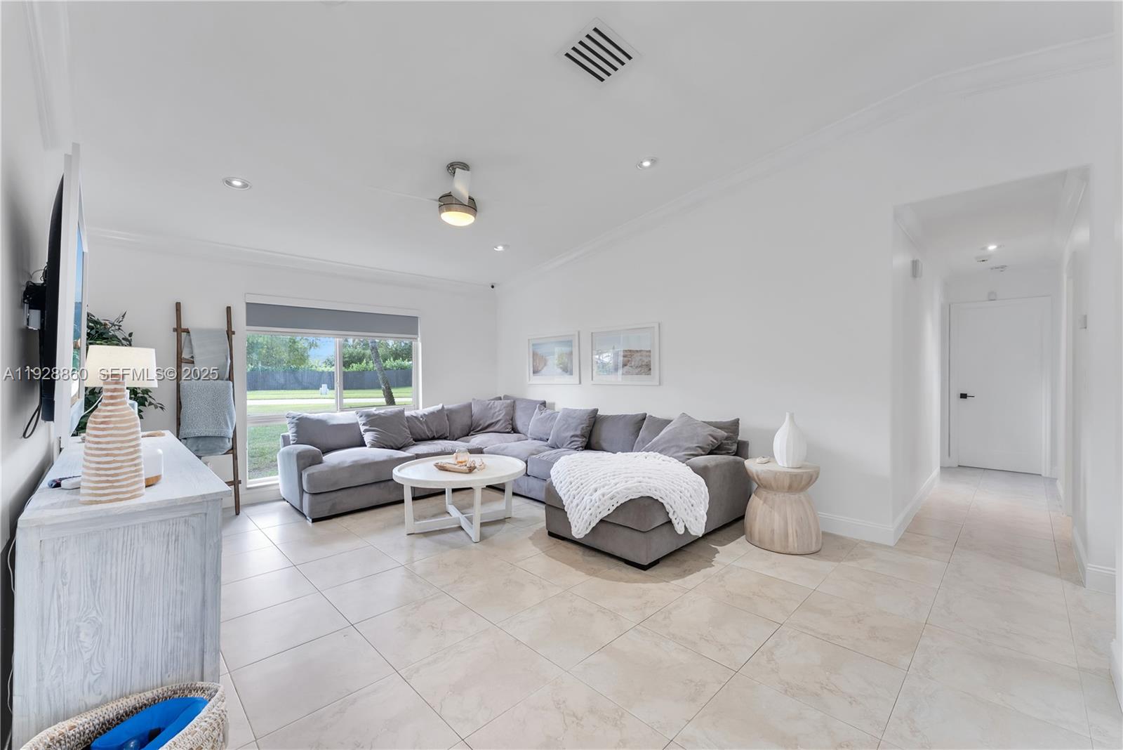 15151 Southwest 164th Terrace Miami, FL 33187 - Photo 11 of 37 a living room with furniture and a large window