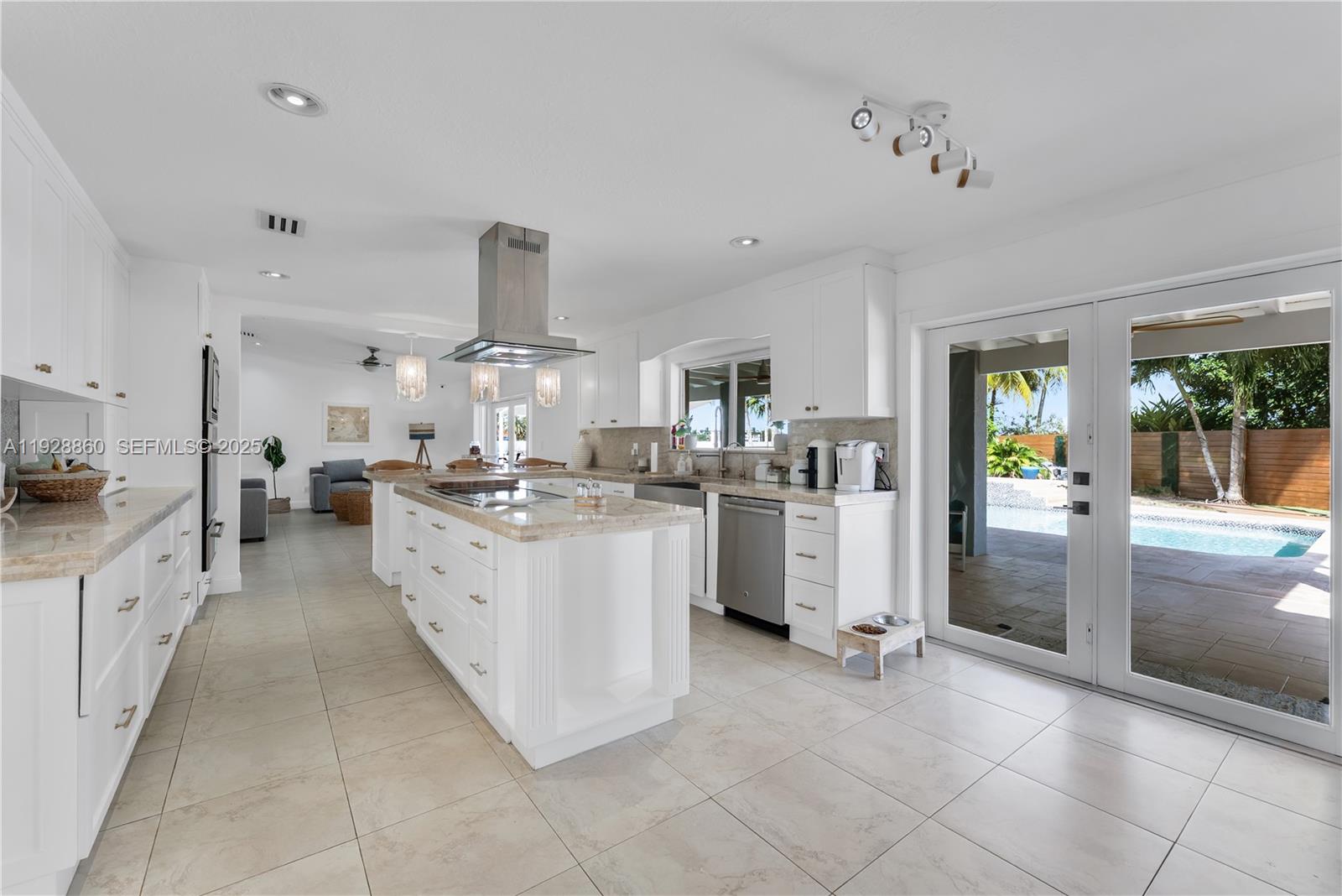 15151 Southwest 164th Terrace Miami, FL 33187 - Photo 5 of 37 a kitchen with white cabinets and appliances