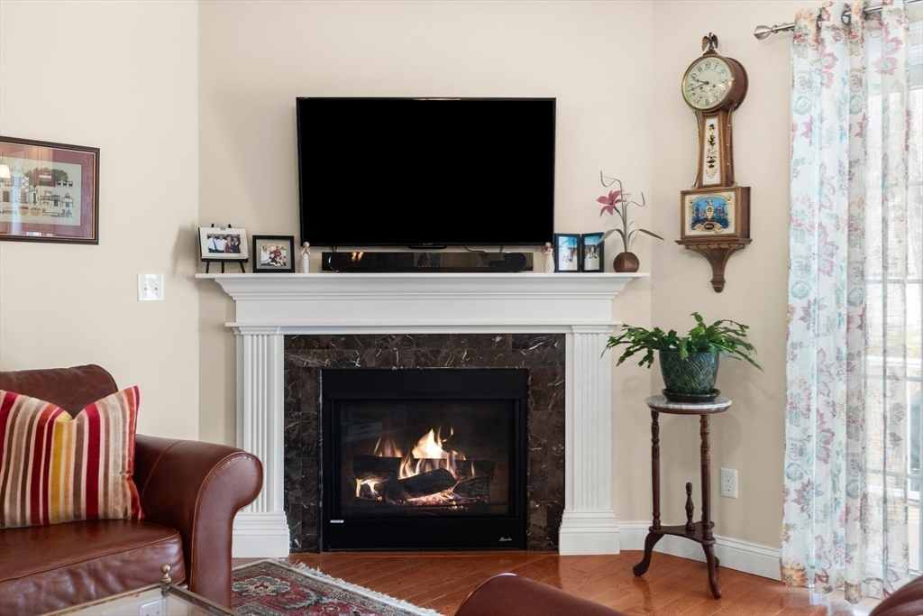 20 Freedom Way, Unit 20 Merrimac, MA 01860 - Photo 12 of 35 a living room with furniture a fireplace and a flat screen tv
