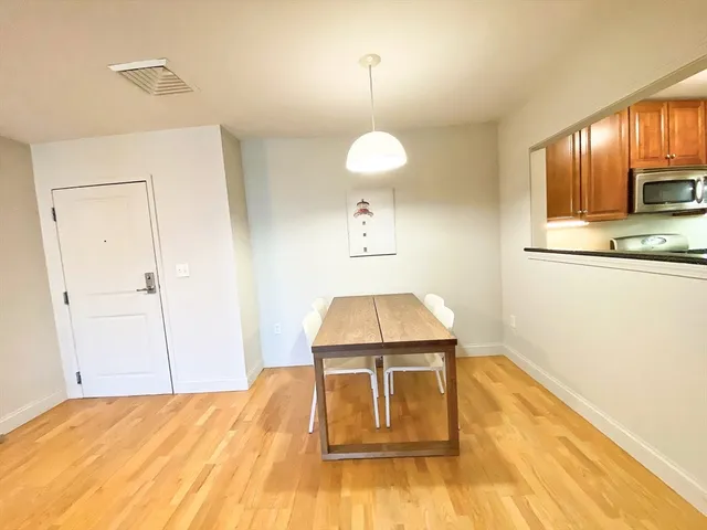 a living room with a bed furniture and a flat screen tv