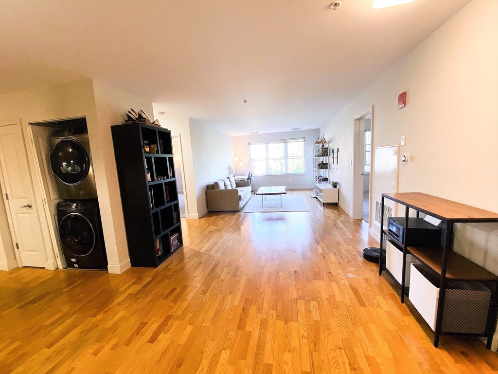 318 Rindge Avenue, Unit 405 Cambridge, MA 02140 - Photo 12 of 25 a view of a living room with furniture and wooden floor