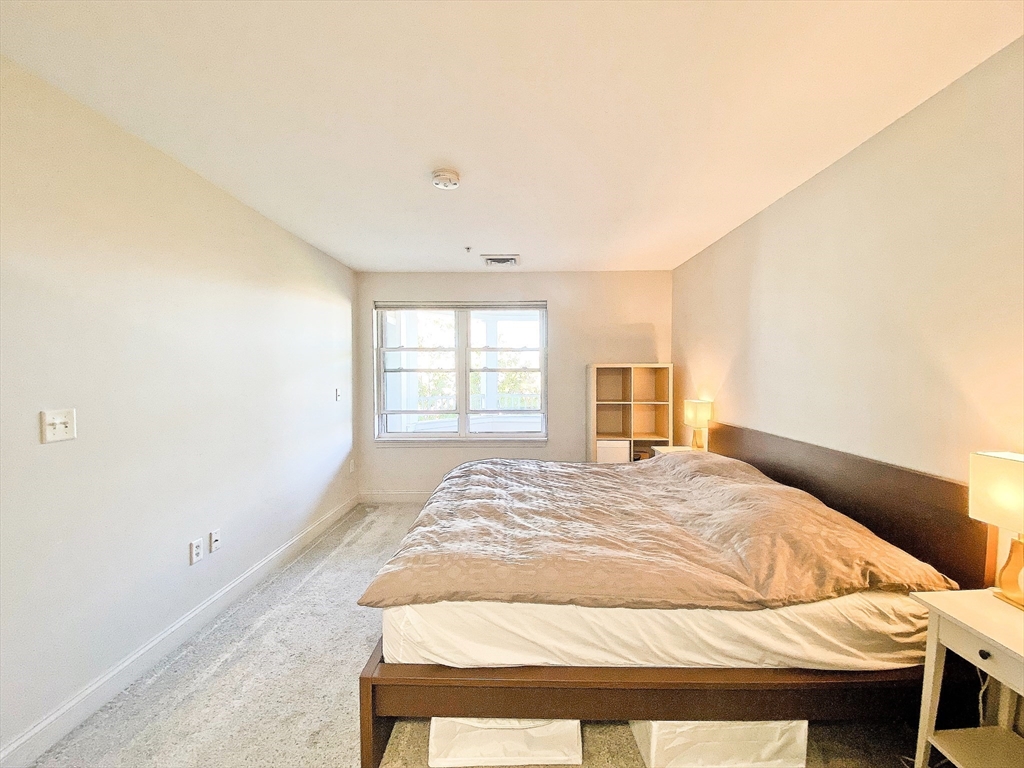 318 Rindge Avenue, Unit 405 Cambridge, MA 02140 - Photo 15 of 25 a bedroom with a bed and a window