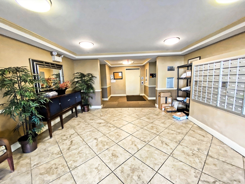 318 Rindge Avenue, Unit 405 Cambridge, MA 02140 - Photo 2 of 25 a bedroom with a bed and a large window