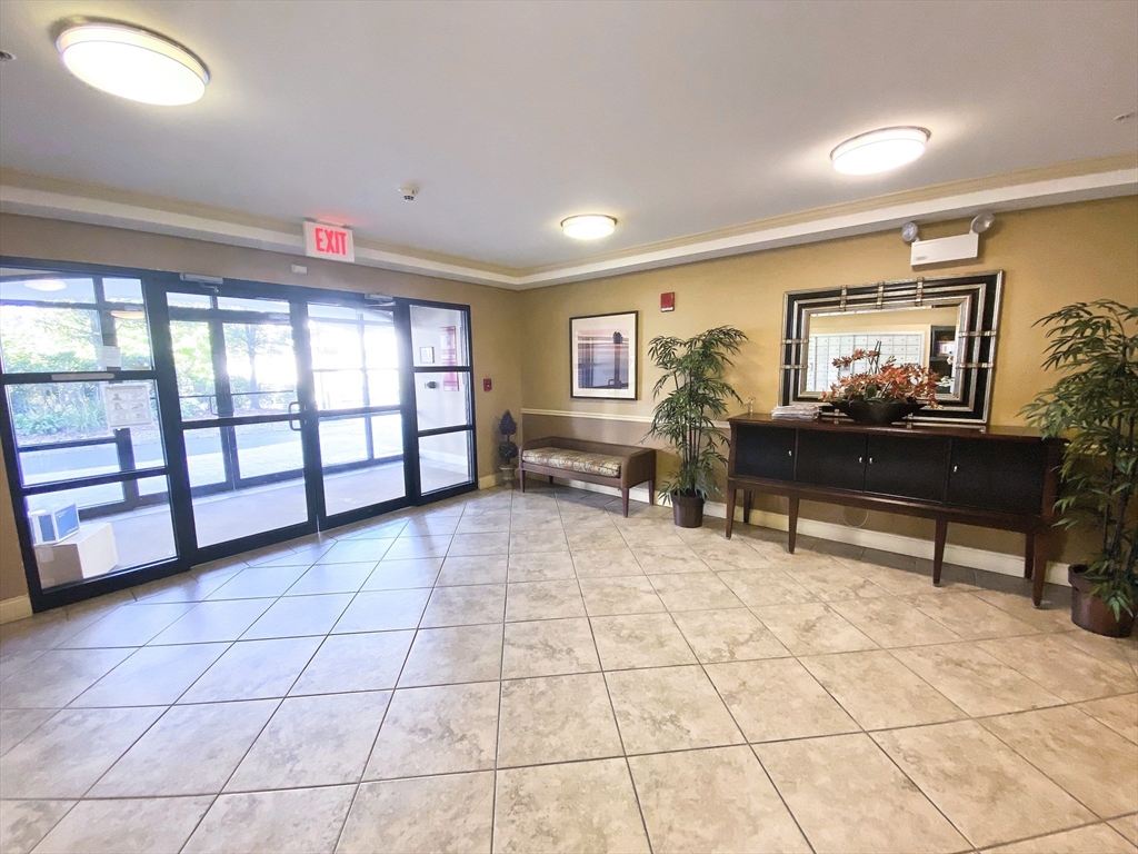 318 Rindge Avenue, Unit 405 Cambridge, MA 02140 - Photo 3 of 25 a living room with furniture and a table