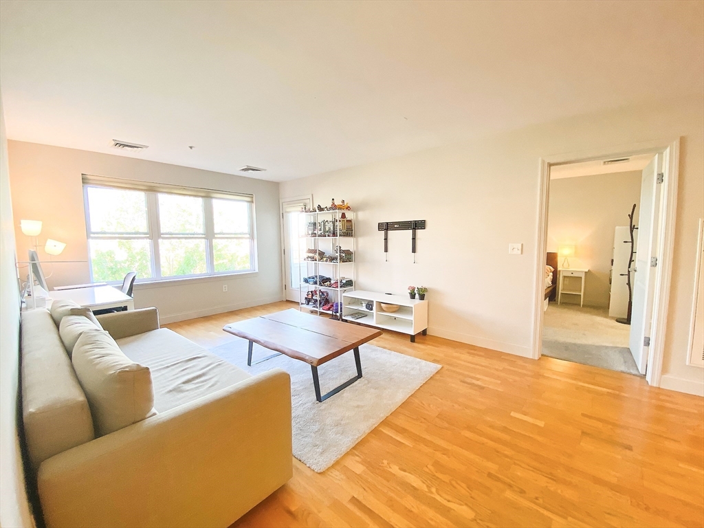 318 Rindge Avenue, Unit 405 Cambridge, MA 02140 - Photo 7 of 25 a living room with furniture and a table