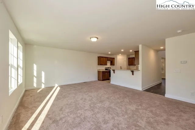 a bathroom with a granite countertop sink a toilet and a mirror