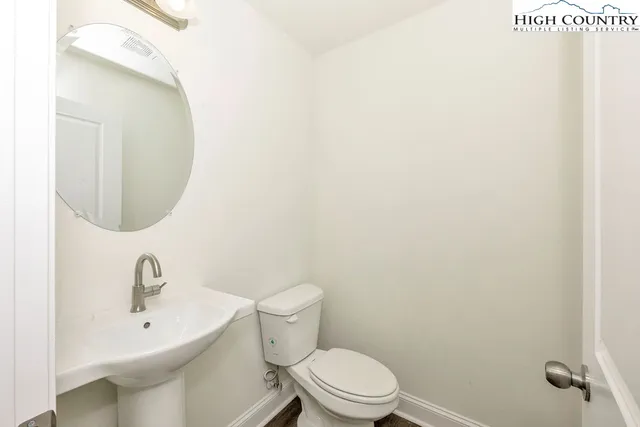 a bathroom with a granite countertop sink a toilet and shower