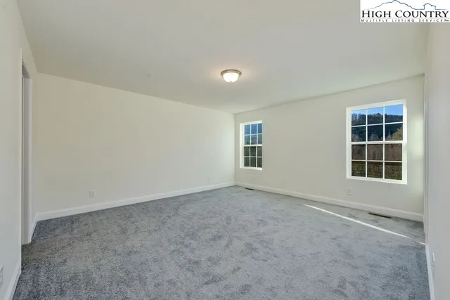 a bathroom with a granite countertop sink a toilet and a mirror