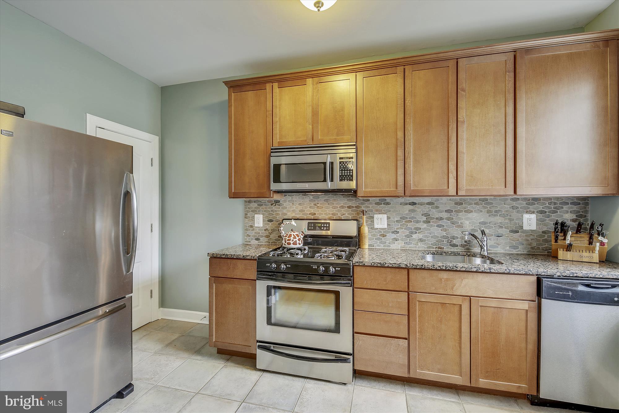1816 Kalorama Road Northwest, Unit 302 Washington, DC 20009 - Photo 8 of 45 Granite counter tops, ceramic backsplash