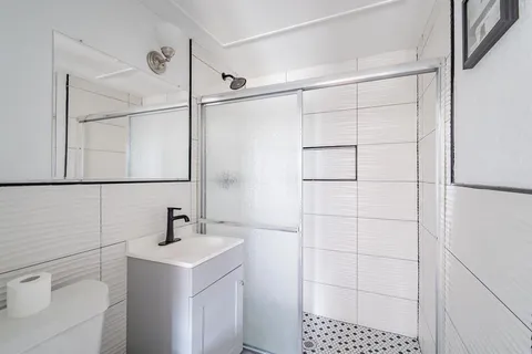 a bathroom with a sink toilet and shower