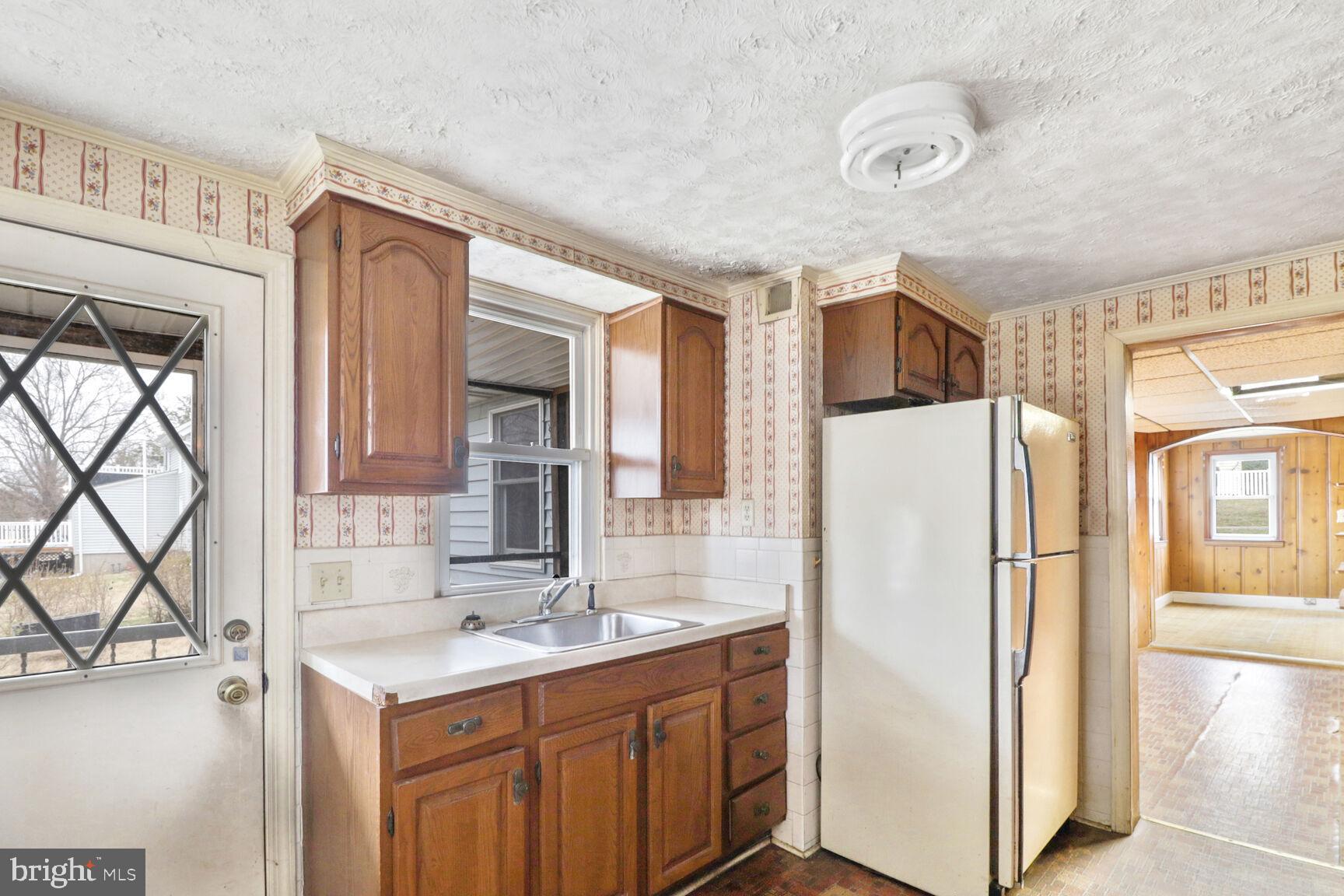 6250 Old Washington Road Elkridge, MD 21075 - Photo 11 of 28 a kitchen with a refrigerator a sink and a stove top oven